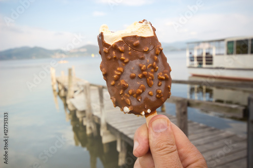 chocolate ice cream / Hand holding bitten ice cream / Ice Cream holded by hand / hand holding ice cream / ice cream