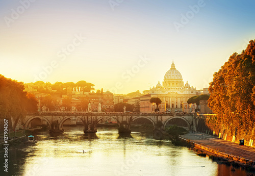 St. Peter's cathedral over bridge and river in Rome at sunset, Italy, retro toned