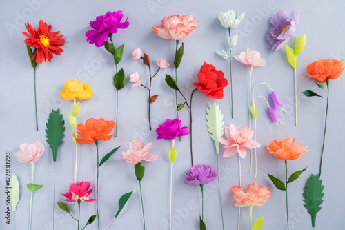 Colourful handmade paper flowers on light blue background