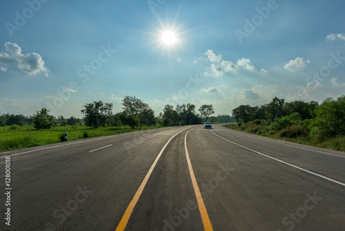 asphalt road and sun on blue sky