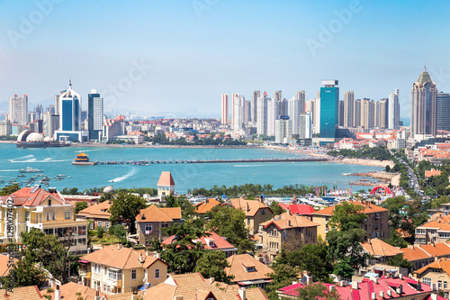 Qingdao Bay with Zhanqiao Pier seen from the hill of XiaoYuShan Park, Qingdao. Zhanqiao is the famous pavilion displayed on the bottles of Qingdao beer