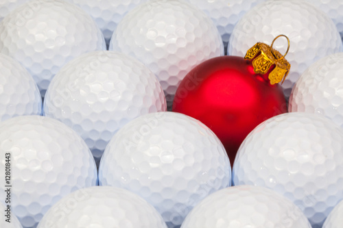 Red Christmas decoration between the golf balls