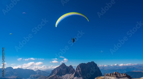 Paraglider flying over mountains 