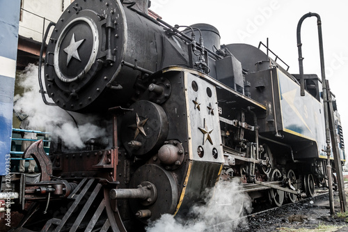 Old steam engine locomotive train and smoke at Ooty trains station, Nilgiri Mountain Railway, India 