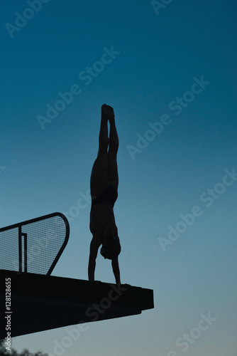 Handstand diver on diving platform