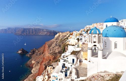 Greece. Santorini Island. Traditional blue dome church in the village of Oia and Cycladic white washed houses