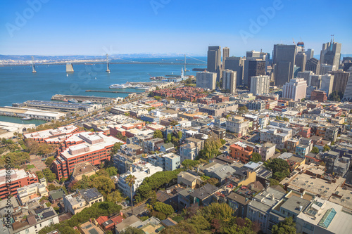 Aerial panorama of San Francisco Financial District, Embarcadero and Oakland Bridge, from top of Coit Tower on sunny day, California, United States.