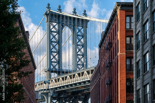 The Manhattan Bridge and a Brooklyn street sidelined by old red brick buildings