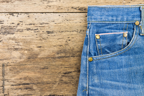 Blue jeans on brown wooden background.Close up of blue jeans ,Bl