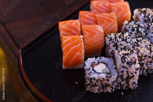 Japanese sushi rolls filadelfia on black stone outdoor