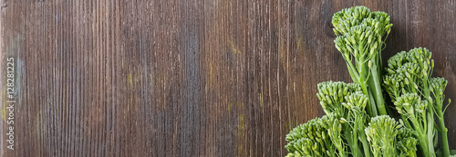 Fresh green broccoli on a wooden board. Dark background. Space f