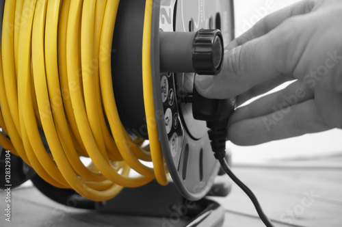 Abstract image of a man connecting plug to an extension lead