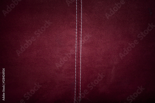 Red alcantara leather background texture with stitching