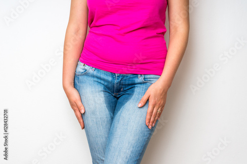 Woman with hands holding her crotch - incontinence concept