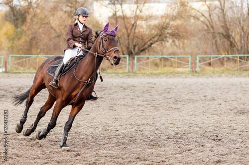 Sportswoman riding horse on equestrian competition