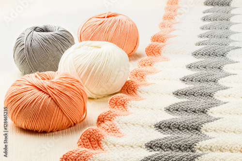 rolls of soft knitting yarn and knitting