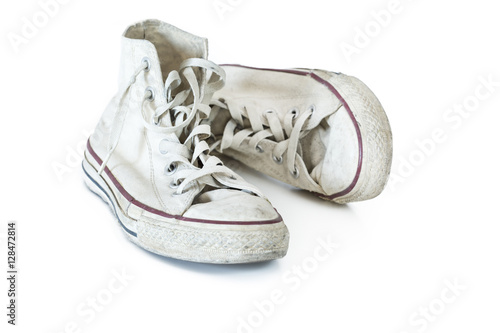 Old white sneakers on white background