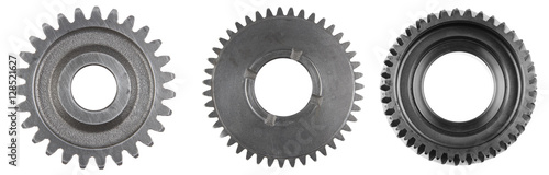 Three steel cog gears isolated over white