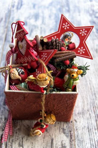 Typical Christmas decorations in a box on wooden background