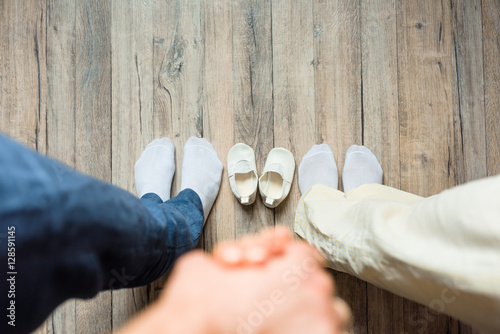 Family picture, spouses holding hands, top view