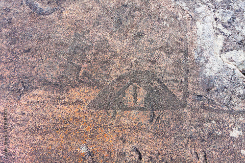 Ancient petroglyphs (rock engravings of 4th-2nd millennia BC) that depict duck carved on granite Onega Lake shore. Besov Nos cape, Karelia Republic, Russia. 