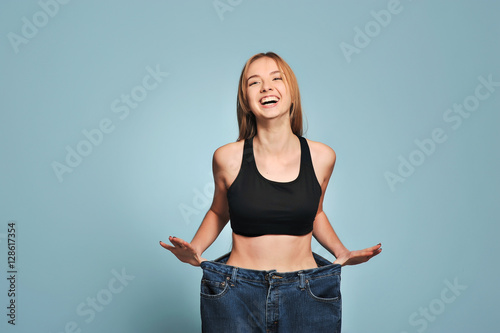 Women shows her weight loss.