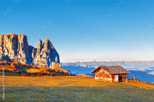 Cabin in Dolomite mountains at rock ans alps at background. Sunrising scene. Beautiful landscape with artistic pos tproduction.