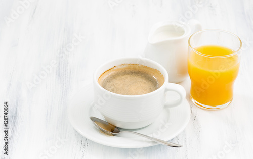 cup of coffee and orange juice on white table