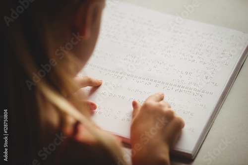 Girl using braille to read