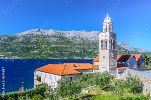 Dominican monastery Korcula island. / View at mediterranean landscape with Dominican Monastery in town Korcula with surfing place Viganj in background, Croatia summertime, Europe.