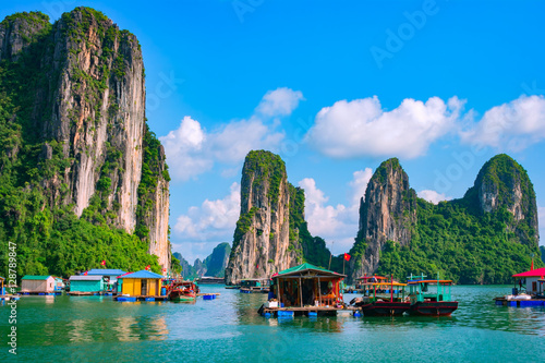 Floating fishing village and rock island in Halong Bay, Vietnam, Southeast Asia. UNESCO World Heritage Site. Junk boat cruise to Ha Long Bay. Landscape. Popular landmark, famous destination of Vietnam