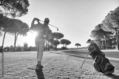 golf player hitting shot with club