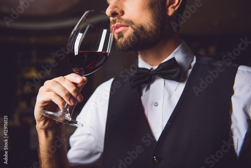 Concentrated sommelier inhaling race of wine