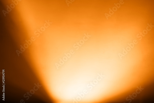 Diagonal orange light from bottom bokeh background