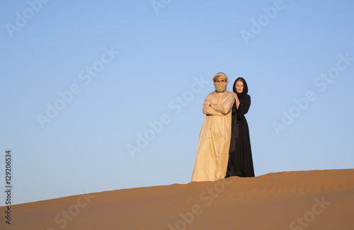 Couple in traditional clothing in a desert near Dubai