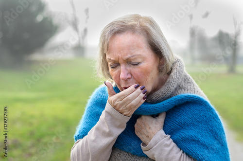 Elderly stylish woman coughing or sneezing