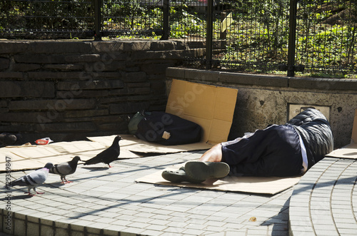 Japanese vagabond people sleeping on floor in public park in mor