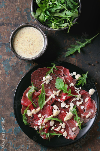 Beef carpaccio with arugula and sauce