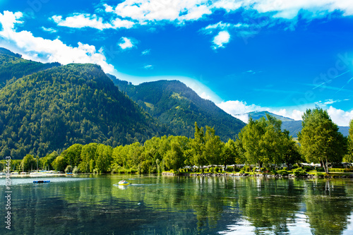 Panoramic view of Zeller See lake. Zell Am See, Austria, Europe. Boats in water. Alps at background.