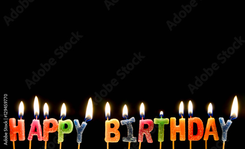 Colorful of happy birthday candle with flame lighting on the black screen
