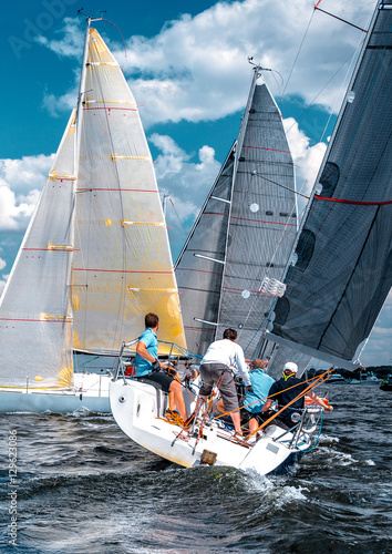 Sailing yacht race, regatta. Team athletes participating in the sailing competition