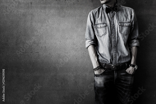 Men's casual outfits standing over grunge background with space, beauty and fashion concept, black and white