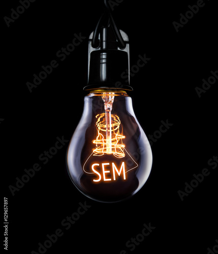 Hanging lightbulb with glowing SEM concept.