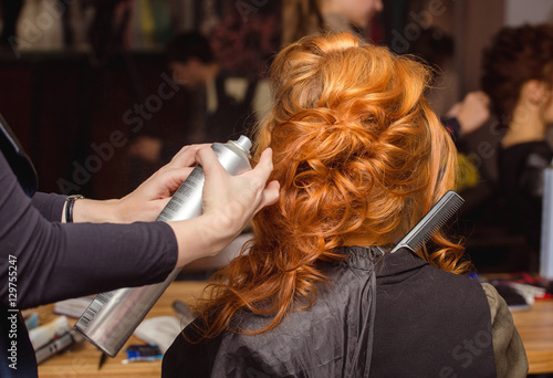 Beautiful red hair woman visit hairdressing salon and doing some styling