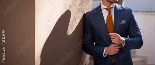 Male model in a suit posing outdoors