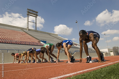 Group of diverse female athletes getting ready to start the race