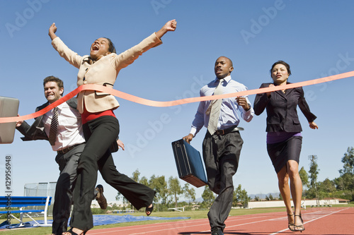 Low angle view of business people crossing the finish line