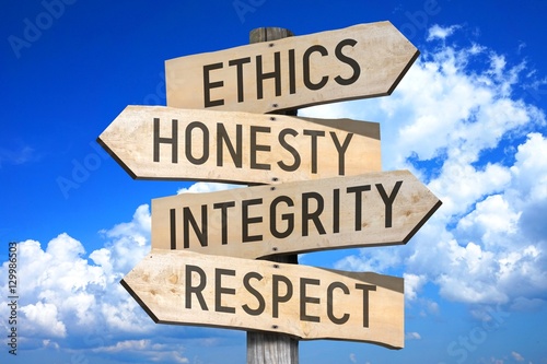 Wooden signpost with four arrows - ethics, honesty, integrity, respect - great for topics like business values etc.