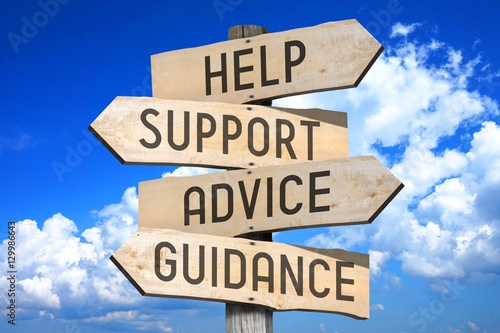 Wooden signpost with four arrows - help, support, advice, guidance - great for topics like frequently asked questions, customer support etc.