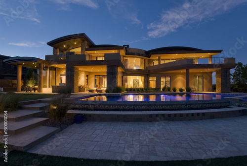 Exterior of modern building with swimming pool at dusk